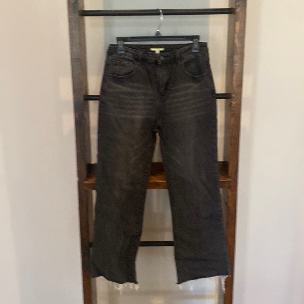 High waisted distressed black jeans with frayed bottom.